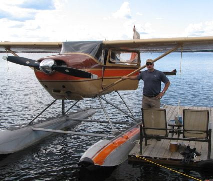 Northern Ontario Lodge Owner Standing Beside Float Plane Aspect Ratio 425 361